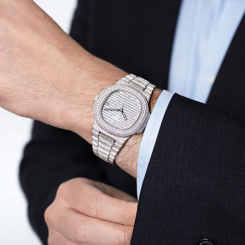 Man in a Black Suit Wearing a White Gold Diamond-Pave Timepiece Around his Wrist.
